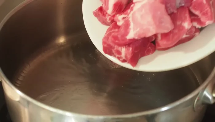 Saler et poivrer la viande.
