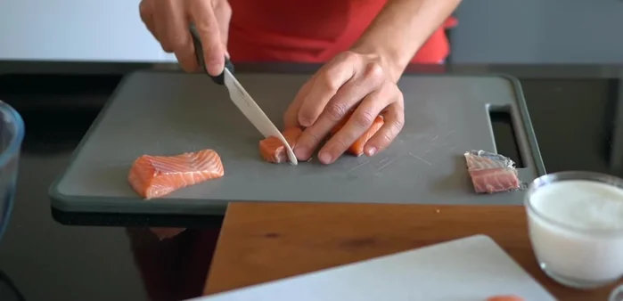 Enlever la peau du saumon et couper en cubes.