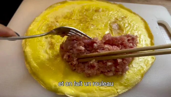 Mettre la viande de porc hachée sur la galette d'oignon. (67.59)