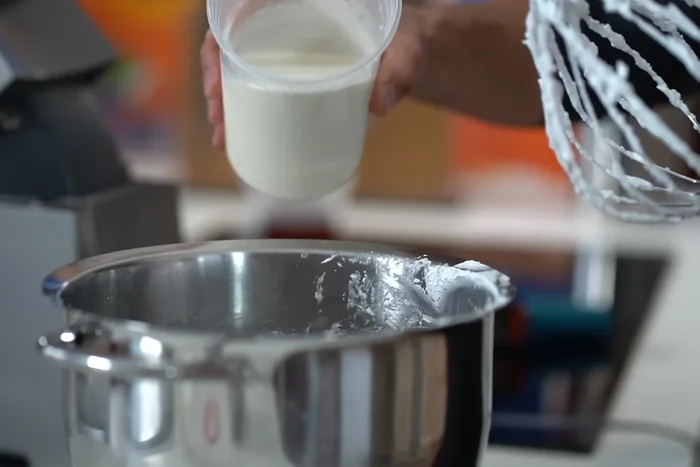 Monter la crème épaisse en chantilly. Incorporer la meringue italienne au mélange de fruits de la passion, puis la crème fouettée.
