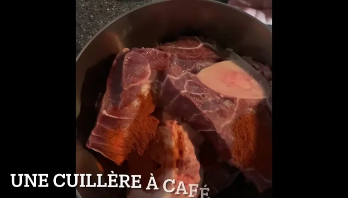 Ajoutez le sel, le paprika, le curcuma, l'huile d'olive, l'huile de tournesol, le gingembre pressé et l'ail pressé. Mélangez bien pour que les épices enrobent la viande.