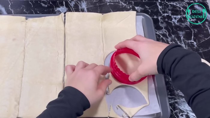 Cuire les disques entre deux feuilles de papier cuisson à 180°C pendant 20 à 25 minutes (ou 30 minutes pour des disques bien dorés et croustillants). Étaler les chutes de pâte feuilletée sur une plaque et cuire en même temps.