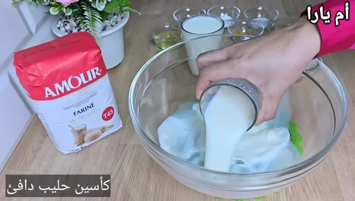 Dans un récipient, mélanger le lait chaud, le sucre, la levure.