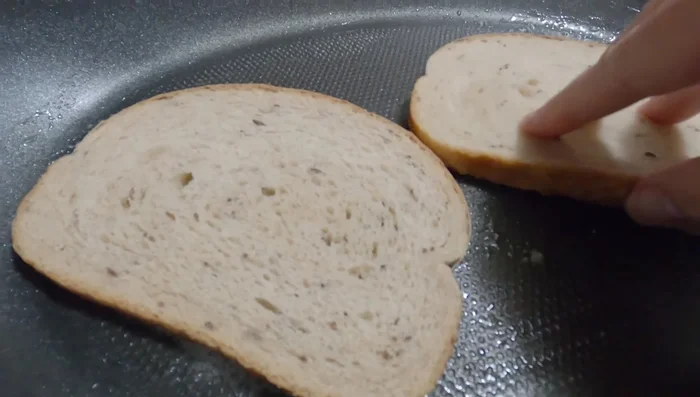 Griller les morceaux de pain de seigle comme un sandwich grillé, ajouter le fromage suisse sur le pain pendant la cuisson.