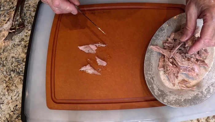 Déchirer la viande de canard en morceaux plus petits.