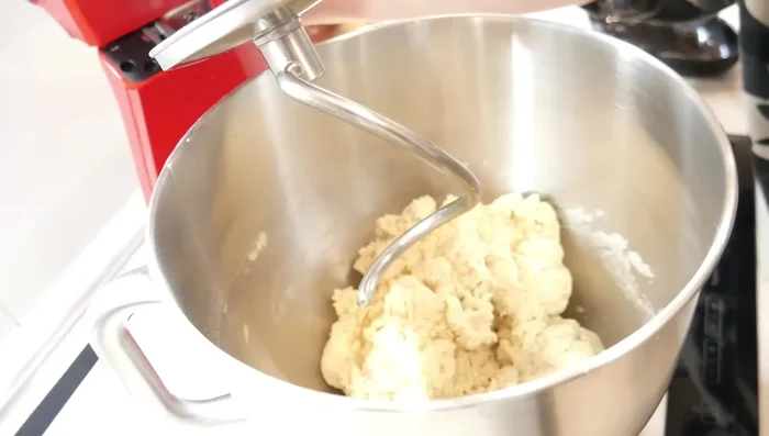 Incorporer le beurre progressivement en pétrissant pendant 10 à 15 minutes jusqu'à obtenir une pâte lisse et homogène.