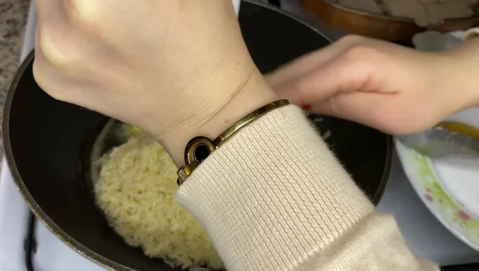 Préparation du Riz : Faire tremper le riz dans de l'eau chaude, puis égoutter. Faire revenir le riz dans une casserole avec de l'huile et du beurre à feu moyen, en remuant régulièrement.