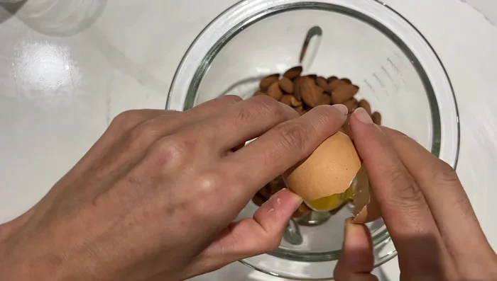 Dans un blender ou hachoir, mixer les amandes, les œufs, le sucre, et le lait. Ne pas mixer trop finement pour garder des morceaux d'amandes.