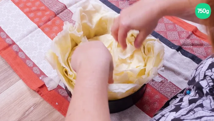 Rabattez au centre la pâte qui dépasse du moule. Pressez délicatement pour bien fermer.