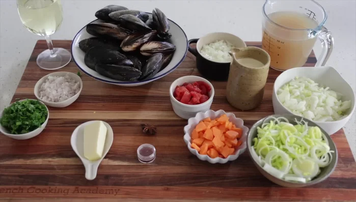 Préparation des moules à la marinara : Faire fondre le beurre, ajouter les échalotes hachées et le persil. Ajouter le vin blanc (150ml), puis les moules. Cuire à feu vif pendant 6 minutes avec le couvercle, en remuant de temps en temps.
