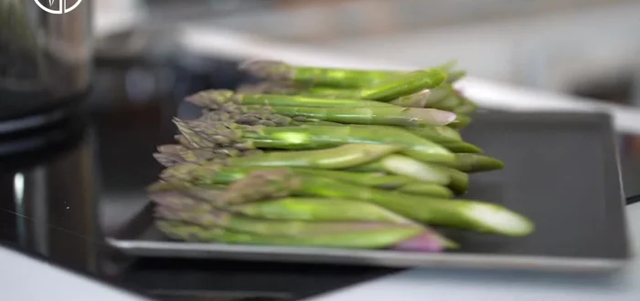 Faites frémir de l'eau dans une casserole avec une cuillère à soupe de sel. Ajoutez les asperges et faites cuire pendant 4 minutes après ébullition. Plongez-les ensuite dans un bain d'eau glacée pour garder leur couleur verte.