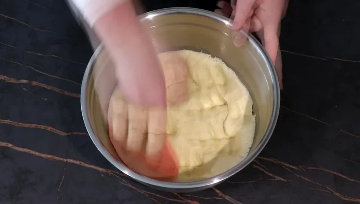 Dégazer la pâte à brioche, former une boule et la remettre au frais 1h après avoir recouvert de film alimentaire. (406.36)