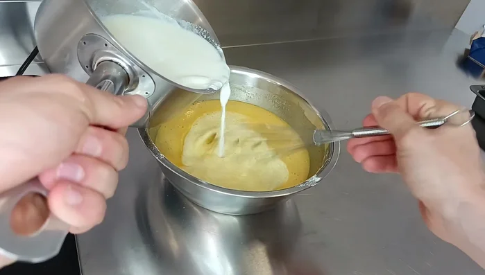 Ajouter le lait chaud à la pâte et mélanger jusqu'à obtenir une pâte homogène.
